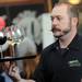 Zingerman's Roadhouse event sever Marcus Stewart balances a tray of wine glasses during the Dining for Dollars fundraiser for HARC at Zingerman's Roadhouse on Wednesday.  Melanie Maxwell I AnnArbor.com